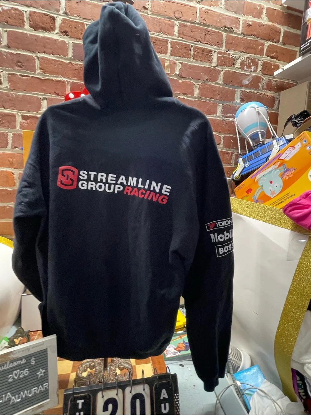 motorsport-style pullover hoodie featuring various sponsor and brand logos